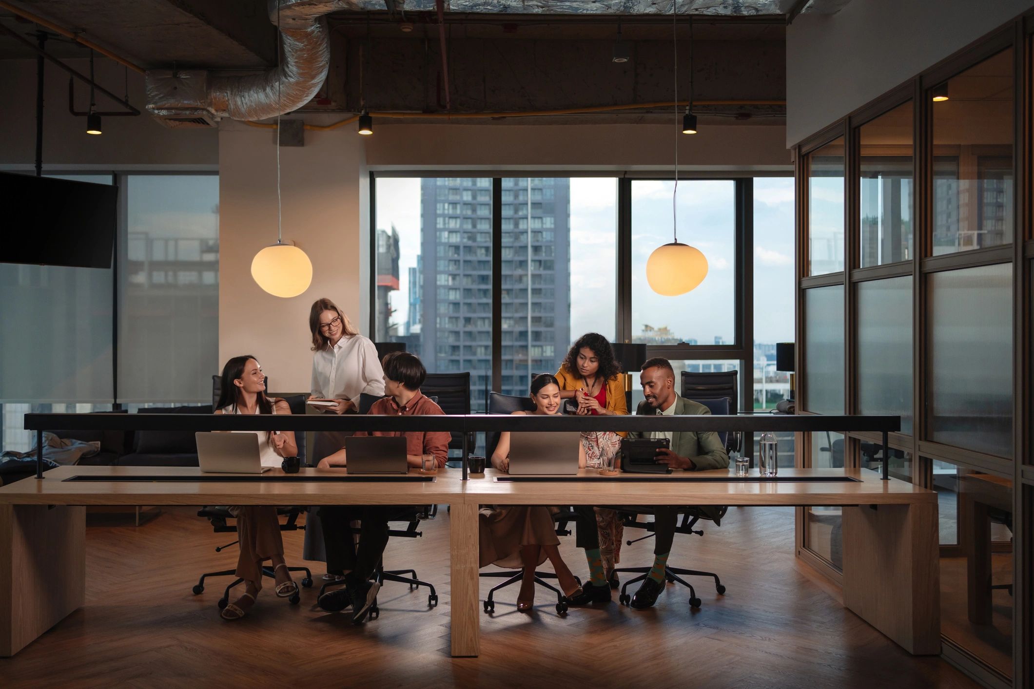 Professional diverse business team in a modern office including a Black male, white male, white female, and another ethnically diverse colleague