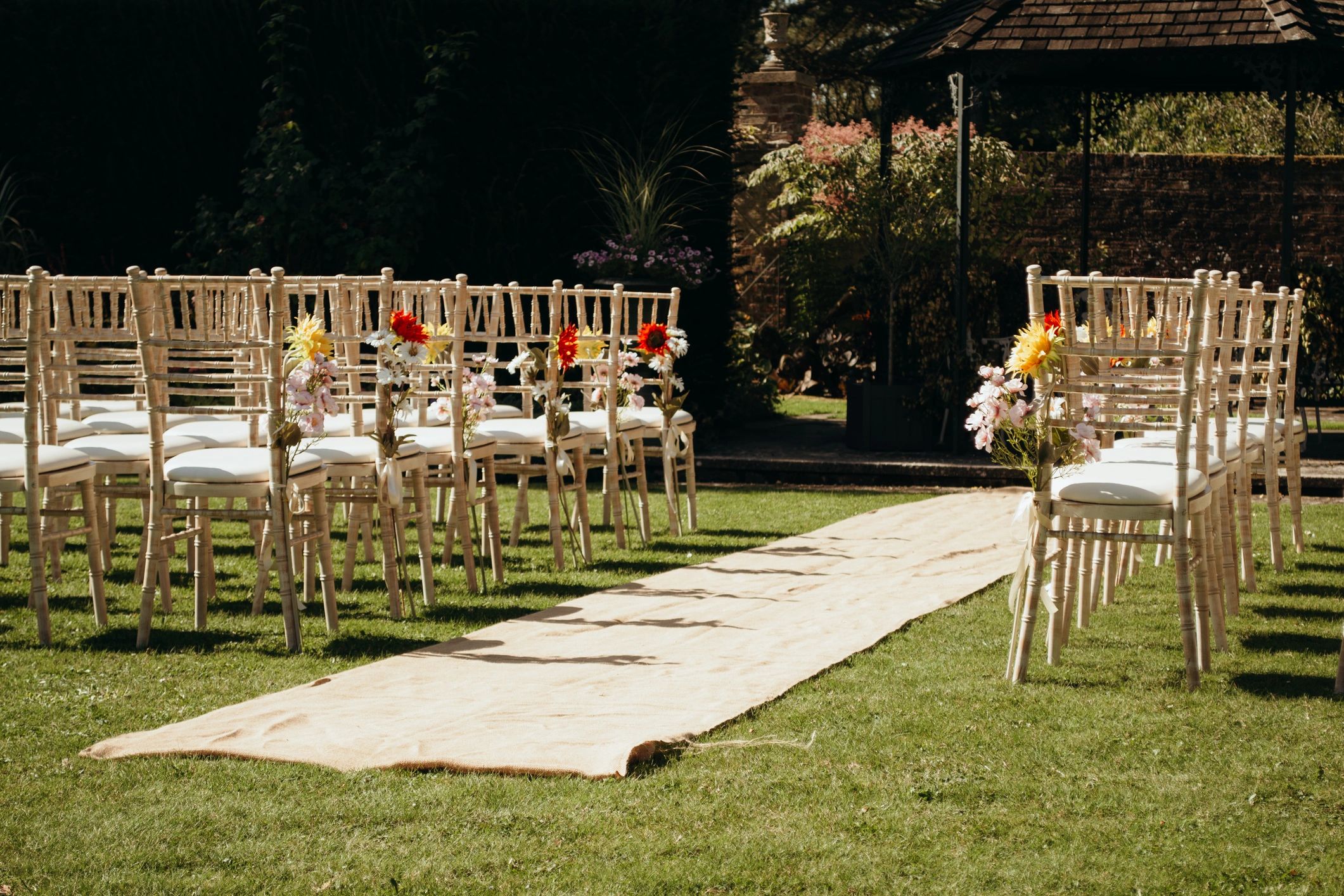 Elegant outdoor wedding venue with ceremony seating and floral decor
